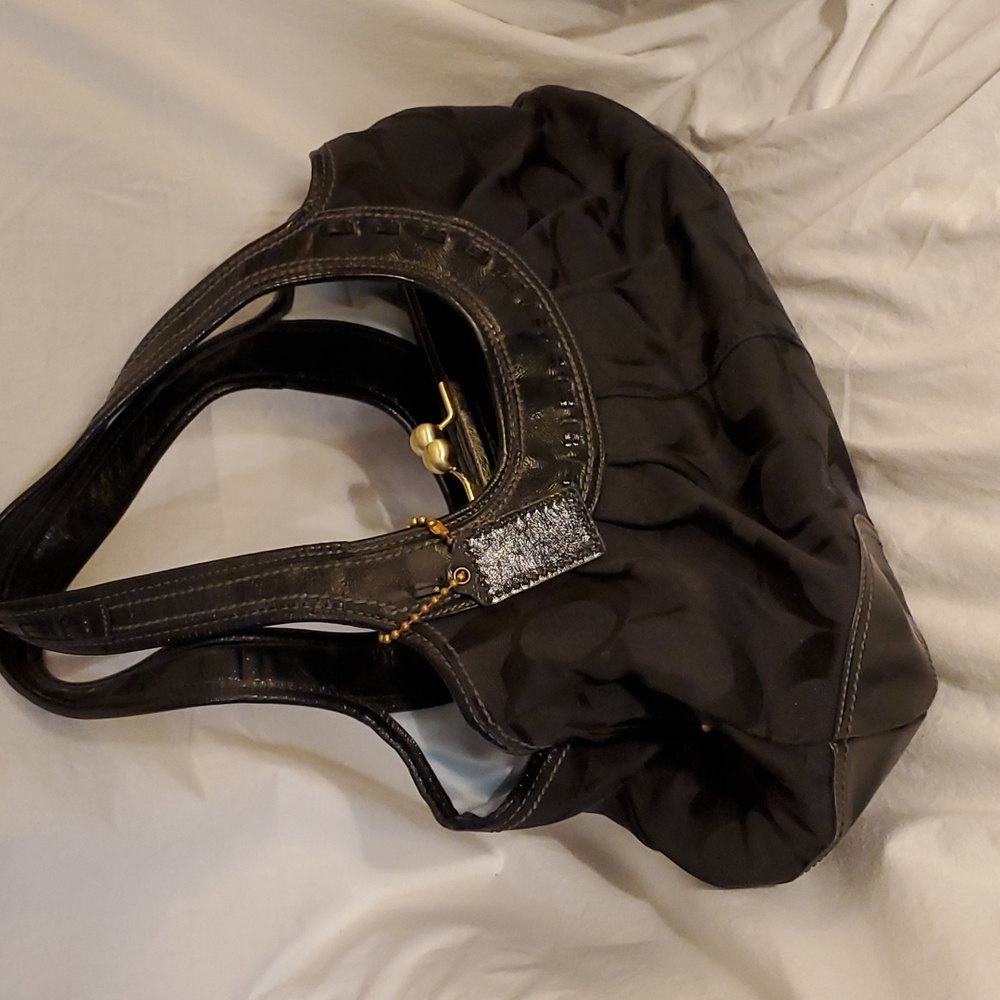 Black Coach handbag 16" wide. 2 handle straps Magnetic closures.